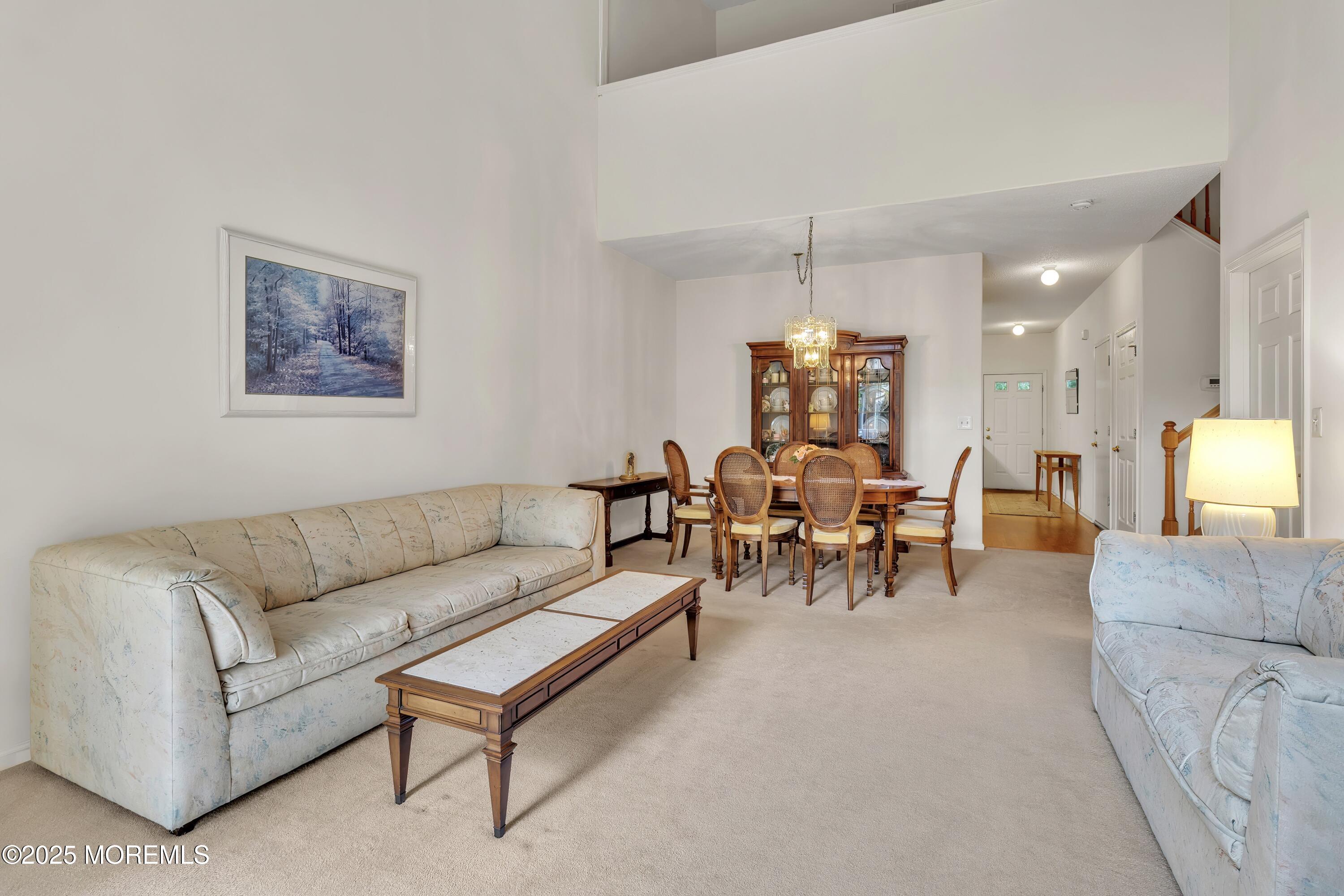 11 Riva Boulevard Brick, NJ 08723 - Photo 21 of 42 a living room with furniture and a chandelier