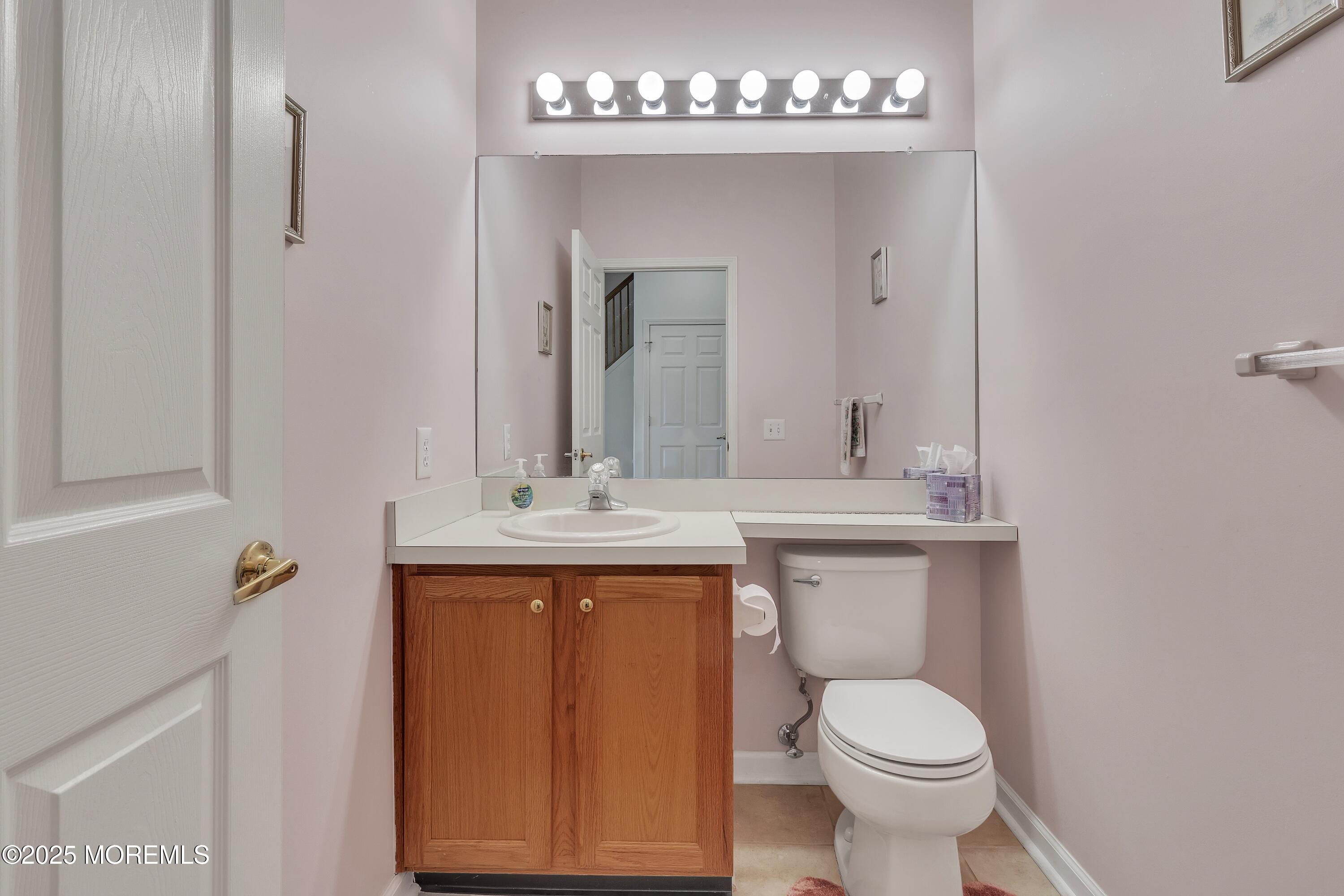 11 Riva Boulevard Brick, NJ 08723 - Photo 23 of 42 a bathroom with a sink a toilet and mirror