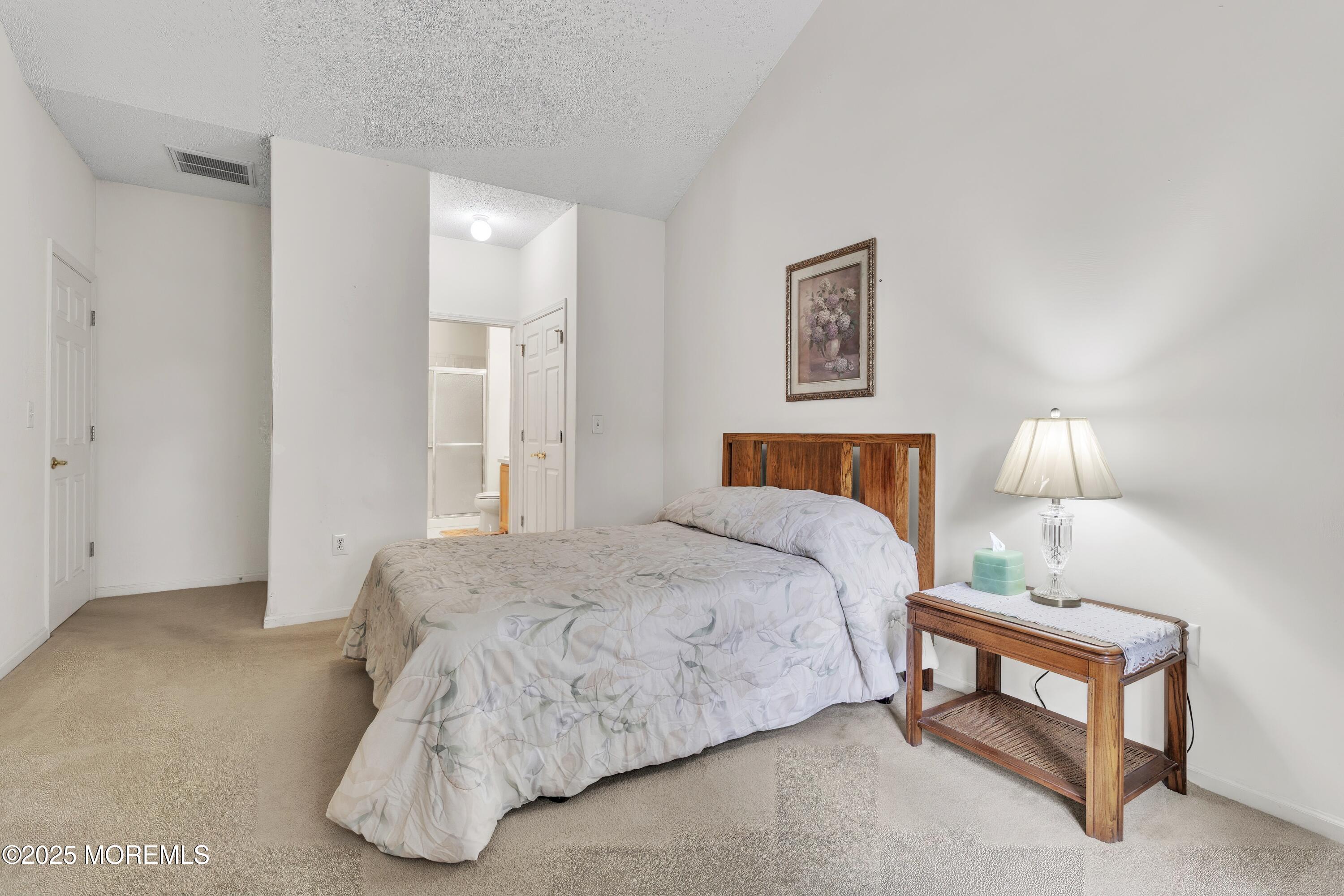 11 Riva Boulevard Brick, NJ 08723 - Photo 26 of 42 a bedroom with a bed and lamp
