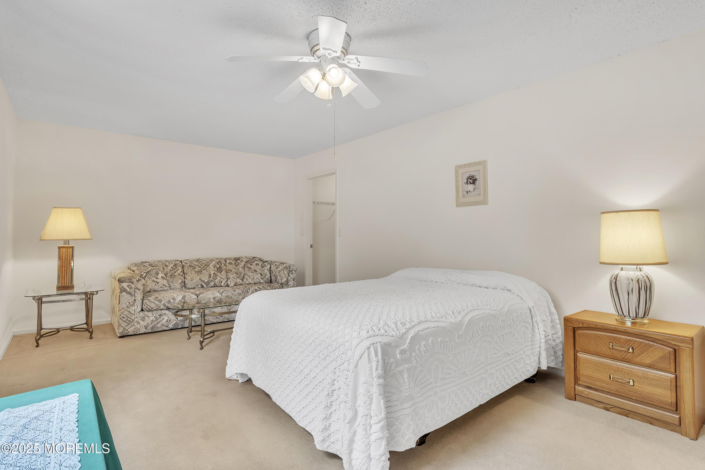 11 Riva Boulevard Brick, NJ 08723 - Photo 35 of 42 a bedroom with a bed and a lamp