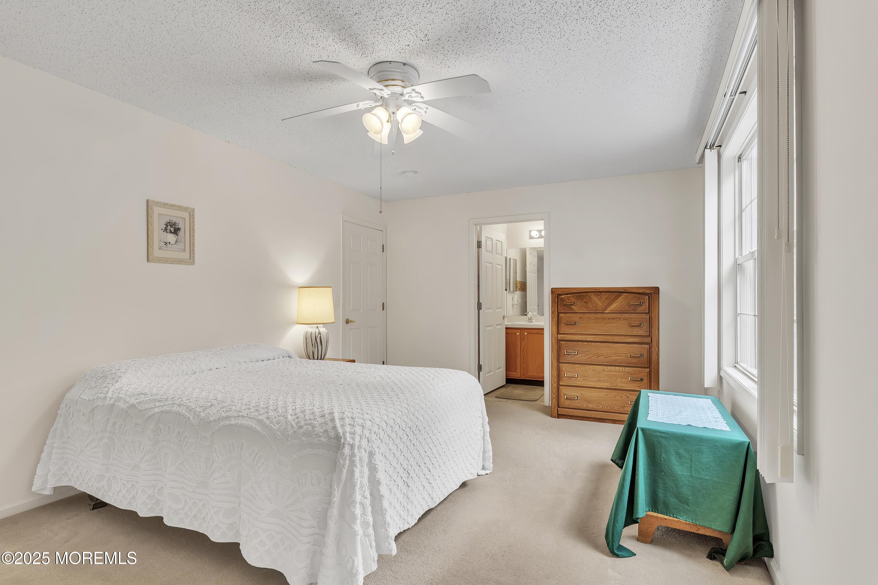 11 Riva Boulevard Brick, NJ 08723 - Photo 36 of 42 a bedroom with a bed and a chandelier