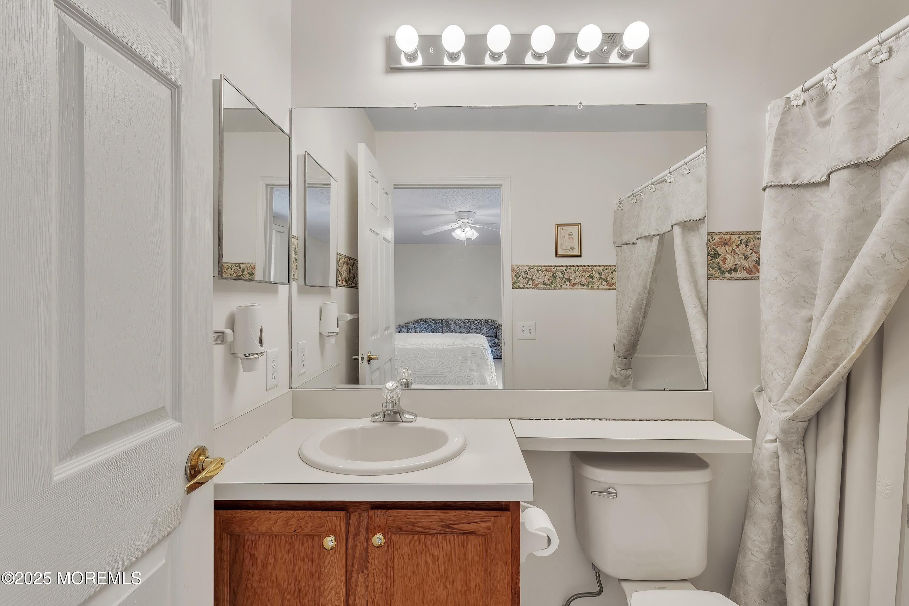 11 Riva Boulevard Brick, NJ 08723 - Photo 39 of 42 a bathroom with a sink a toilet and a mirror