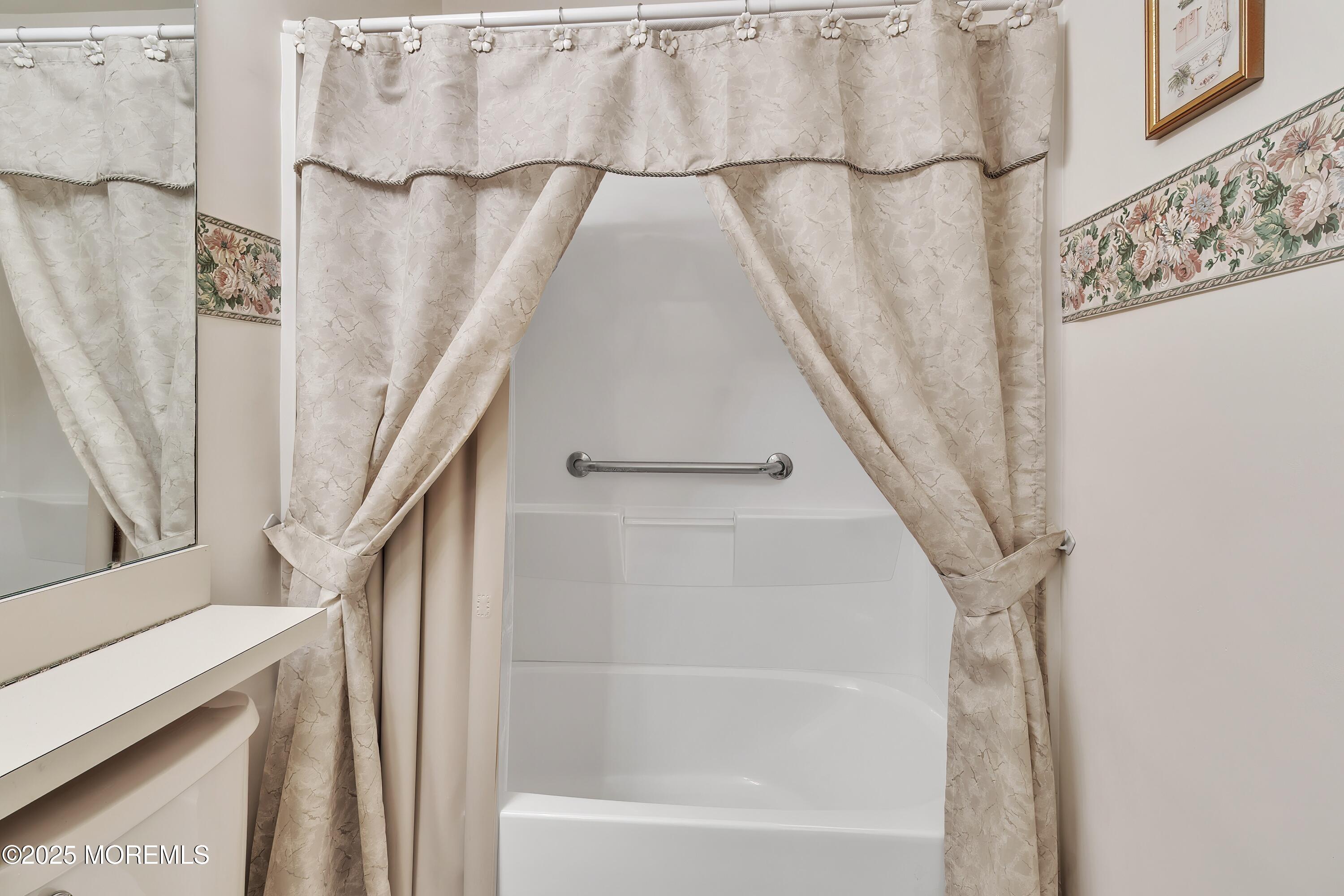 11 Riva Boulevard Brick, NJ 08723 - Photo 40 of 42 a bathroom with a bathtub and a shower