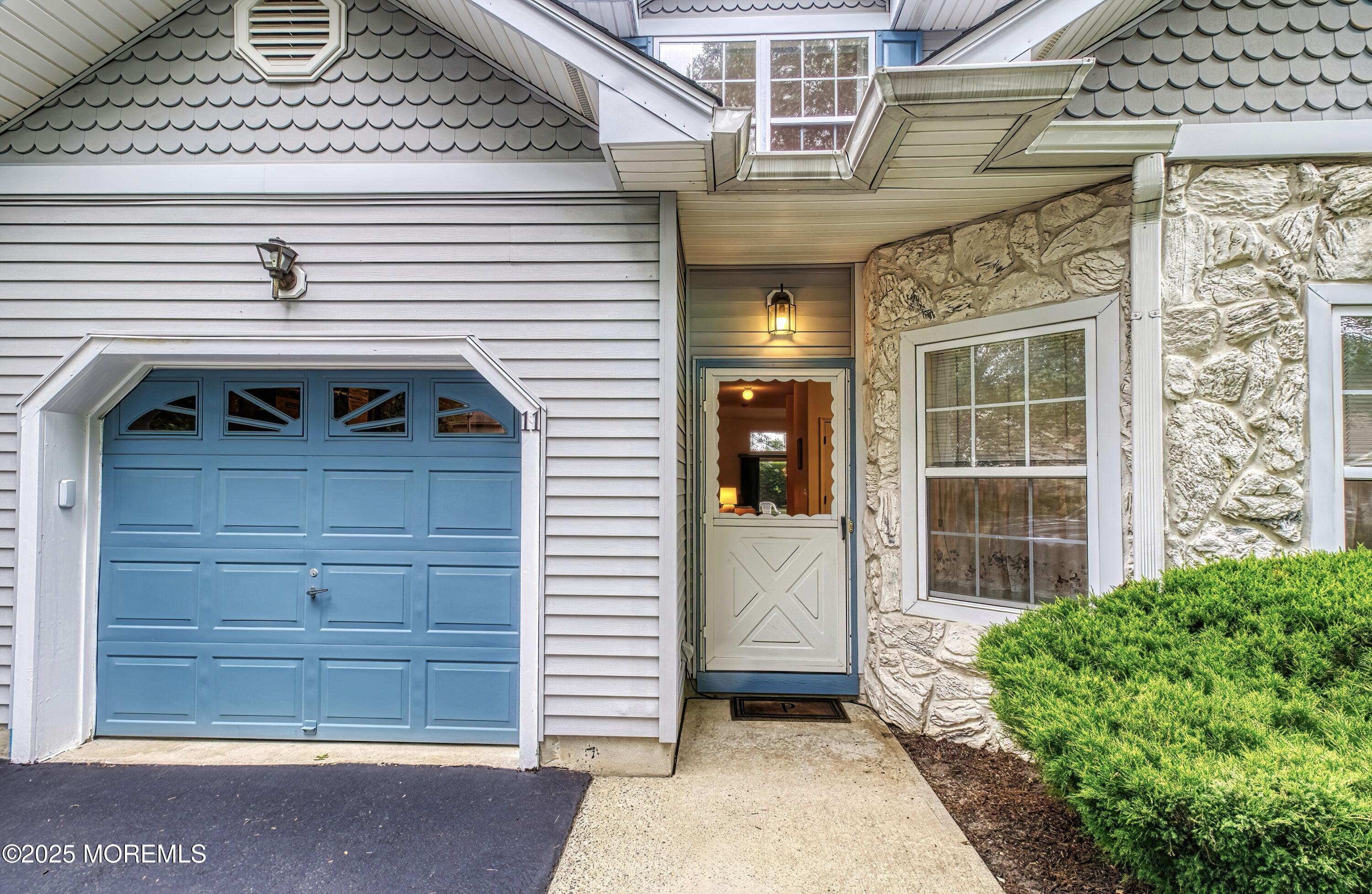 11 Riva Boulevard Brick, NJ 08723 - Photo 10 of 42 a front view of a house with a garage