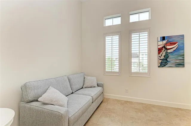 a living room with lots of furniture and kitchen view