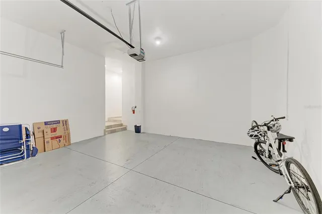 a view of a dining room with furniture a rug and potted plants
