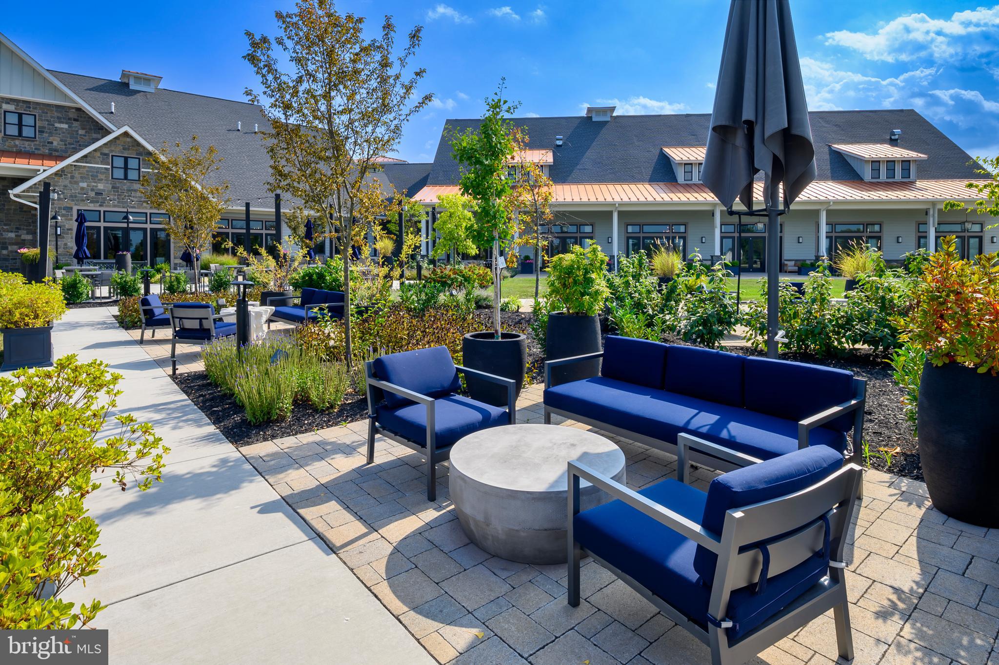 44 Lively Stream Way Gettysburg, PA 17325 - Photo 55 of 70 a view of a patio with couches table and chairs potted plants and a large tree