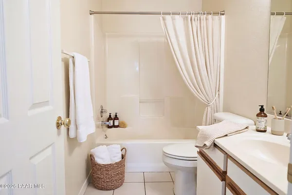 a bathroom with a sink a toilet and shower curtain