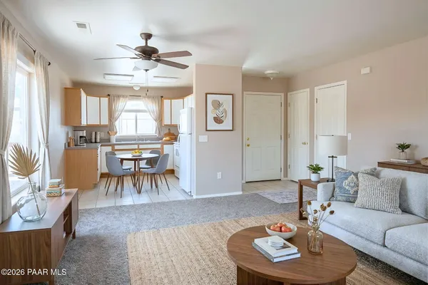 a living room with furniture and a dining table