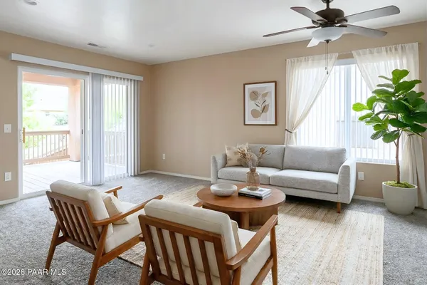 a living room with furniture and a potted plant