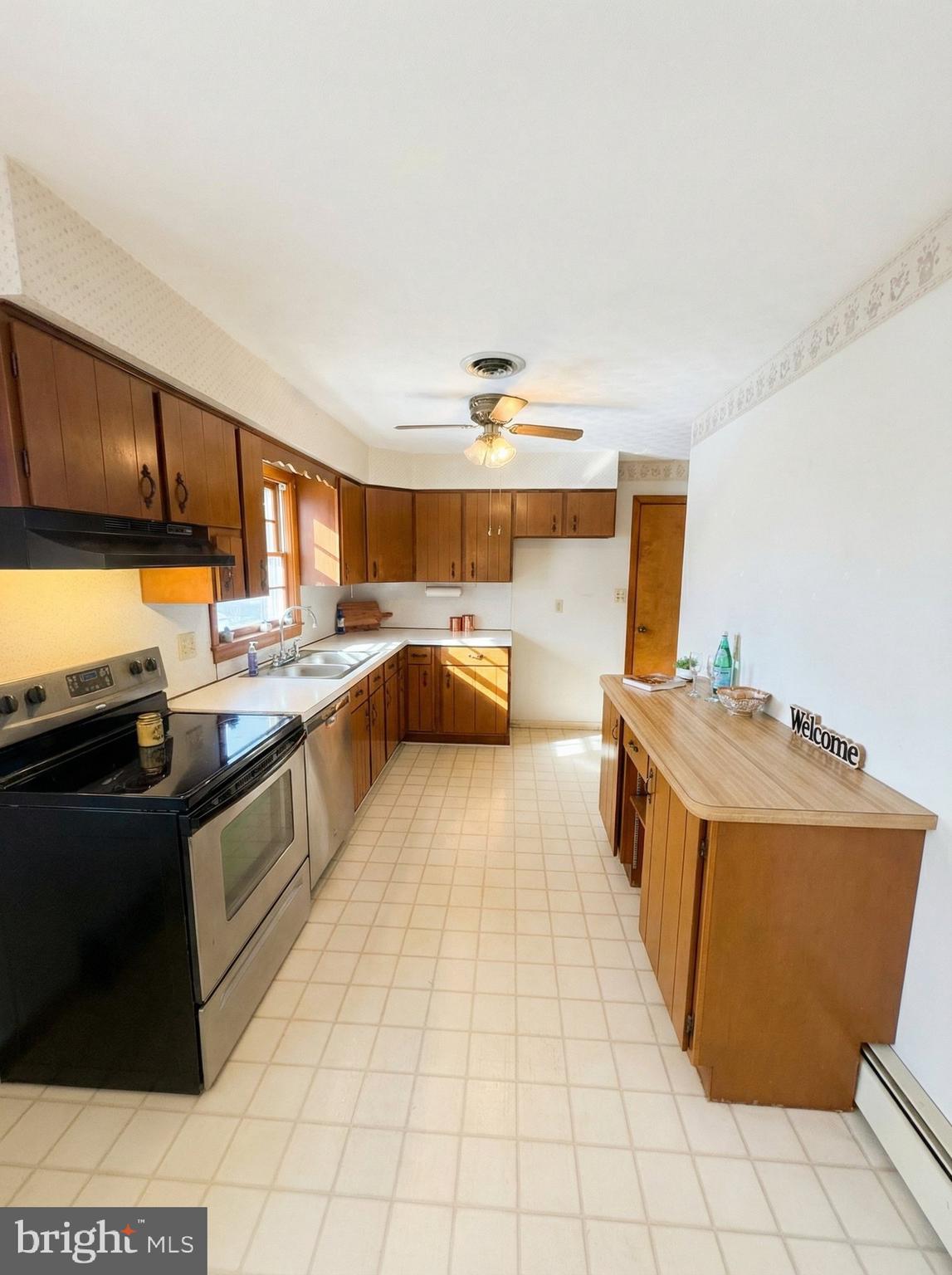 100 Clover Hill Road Dallastown, PA 17313 - Photo 11 of 20 a kitchen with stainless steel appliances granite countertop a sink stove and refrigerator