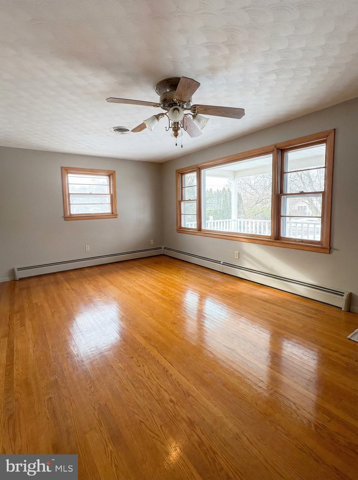 100 Clover Hill Road Dallastown, PA 17313 - Photo 4 of 20 an empty room with wooden floor and windows