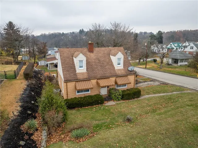 a view of a big yard with large trees