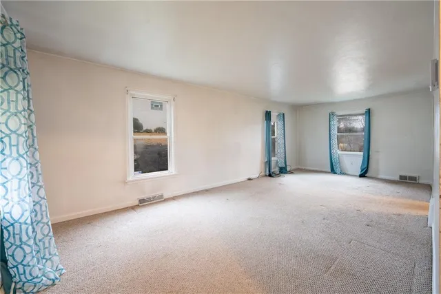 an empty room with a empty space and windows