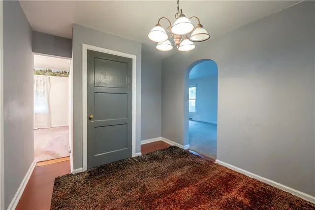 a view of a bedroom with a large bed and wooden floor