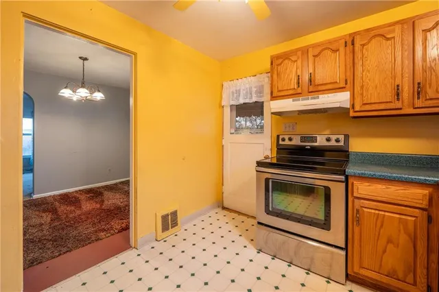 a kitchen with granite countertop cabinets and steel stainless steel appliances