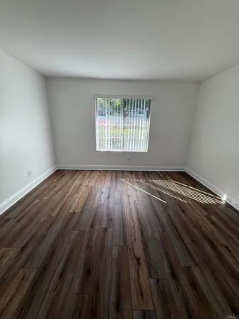 a view of wooden floor in a bedroom