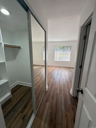 a bathroom with a granite countertop sink toilet mirror and a shower