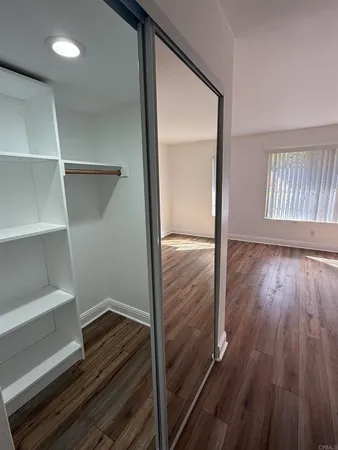 a view of room with wooden floor
