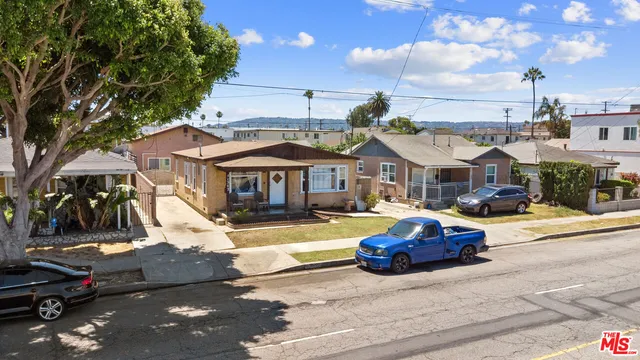 a front view of a residential apartment building with parking space