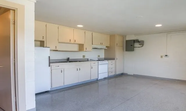 a kitchen with cabinets stove a sink and dishwasher