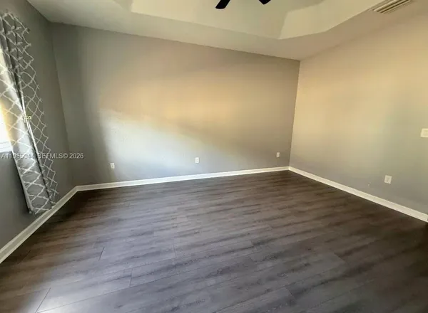 a view of an empty room and wooden floor