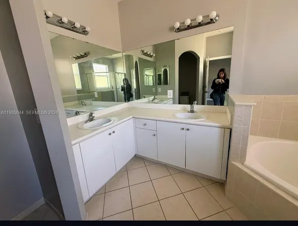 a bathroom with a sink vanity and mirror
