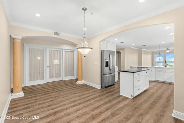 a large white kitchen with a refrigerator a sink and a stove