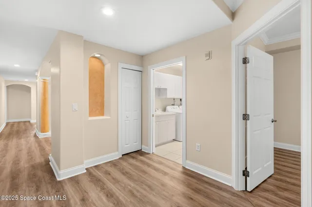 a view of a room with wooden floor