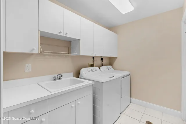 a utility room with sink dryer and washer