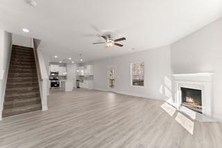 636 Bald Ridge Circle Demorest, GA 30535 - Photo 13 of 35 an empty room with wooden floor a ceiling fan and kitchen view