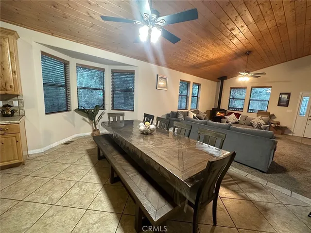 a dining hall with stainless steel appliances granite countertop a dining table and chairs