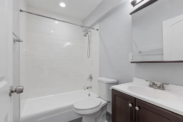a bathroom with a sink toilet vanity and shower