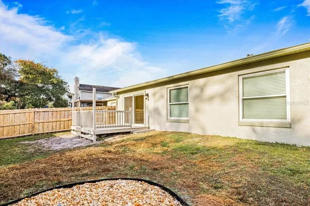 a view of house with backyard
