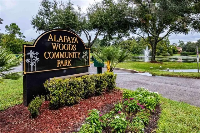a view of a street sign under a large tree