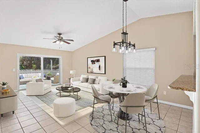 a dining room with furniture a chandelier and window