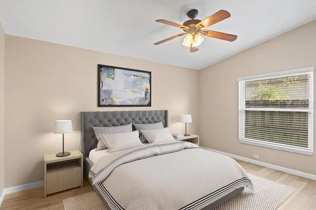 a bedroom with a bed and a chandelier