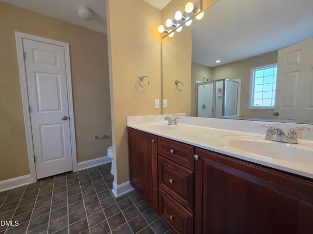 a bathroom with a double vanity sink mirror and