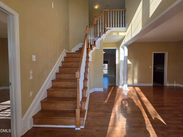 a view of entryway and hall with wooden floor
