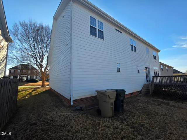 a backyard of a house with barbeque oven and outdoor seating