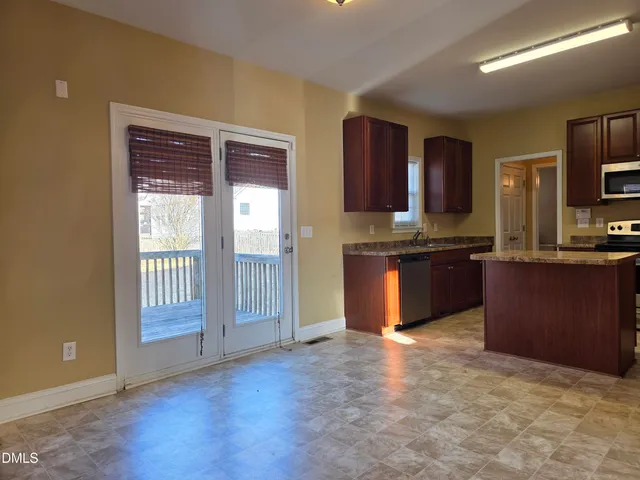 a kitchen with stainless steel appliances granite countertop a stove and a refrigerator