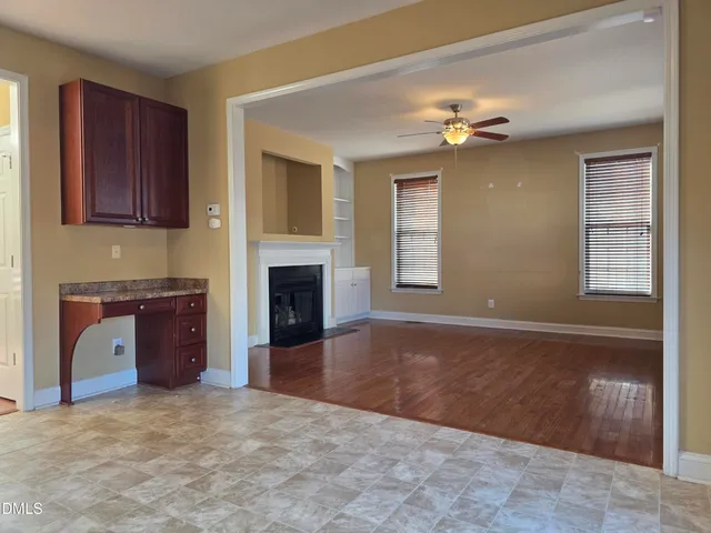 a view of a livingroom with a fireplace and a window