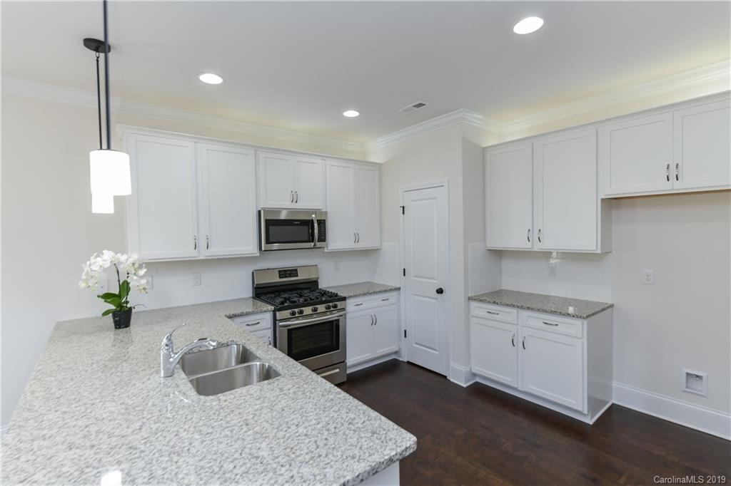 5810 Carmel Road Charlotte, NC 28226 - Photo 12 of 31 a kitchen with granite countertop a sink stainless steel appliances and cabinets