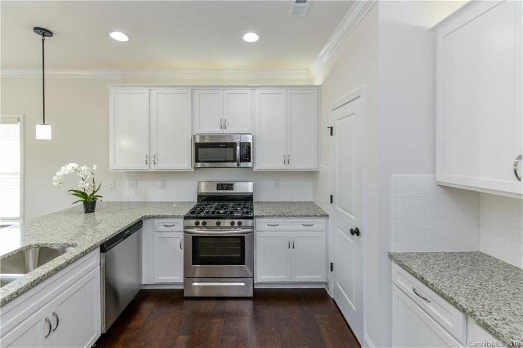 5810 Carmel Road Charlotte, NC 28226 - Photo 13 of 31 a kitchen with stainless steel appliances granite countertop a sink stove and cabinets