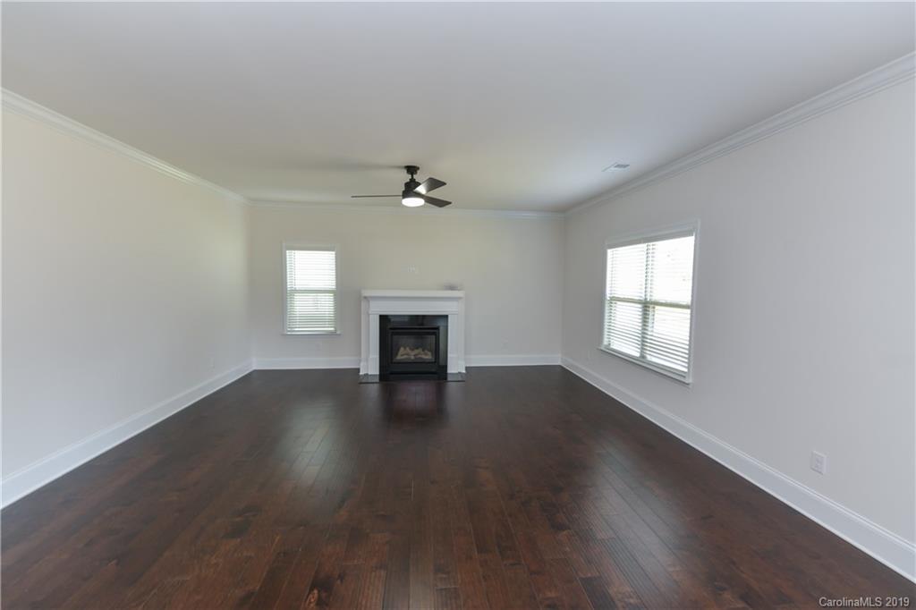 5810 Carmel Road Charlotte, NC 28226 - Photo 15 of 31 a view of an empty room with wooden floor and a window
