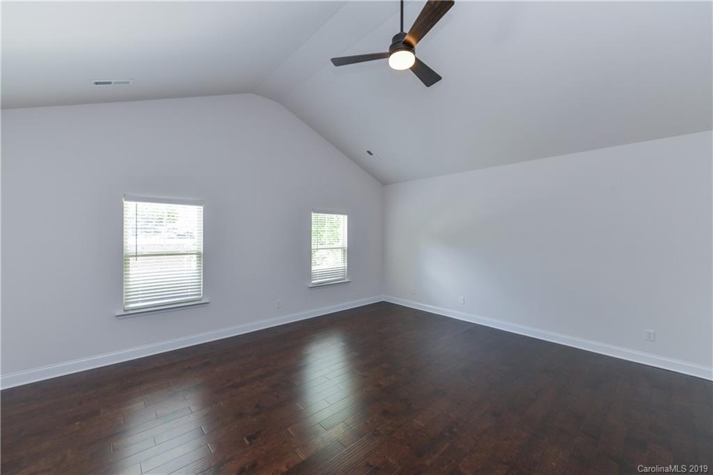 5810 Carmel Road Charlotte, NC 28226 - Photo 19 of 31 an empty room with wooden floor and windows