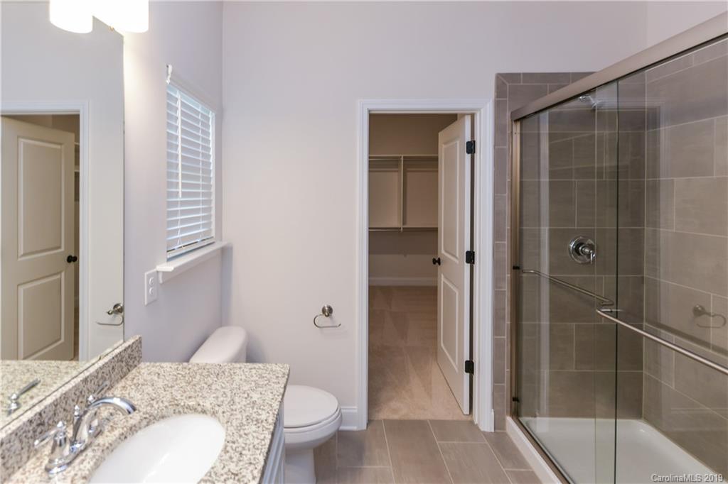 5810 Carmel Road Charlotte, NC 28226 - Photo 20 of 31 a bathroom with a granite countertop sink toilet and shower