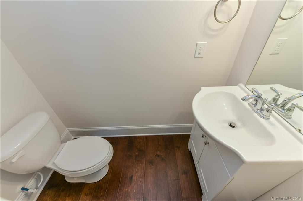 5810 Carmel Road Charlotte, NC 28226 - Photo 26 of 31 a bathroom with a sink mirror vanity and toilet