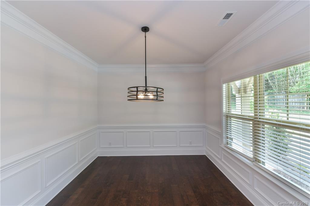 5810 Carmel Road Charlotte, NC 28226 - Photo 6 of 31 a view of a room with window a ceiling fan and wooden floor