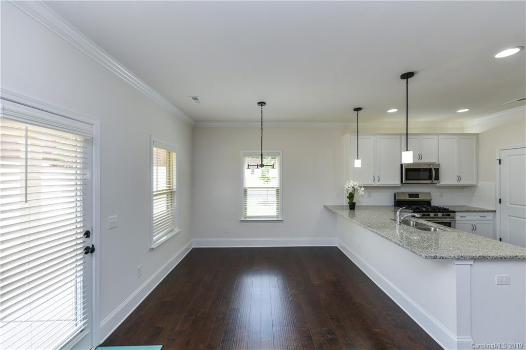 5810 Carmel Road Charlotte, NC 28226 - Photo 10 of 31 a kitchen with stainless steel appliances a refrigerator sink and wooden floor